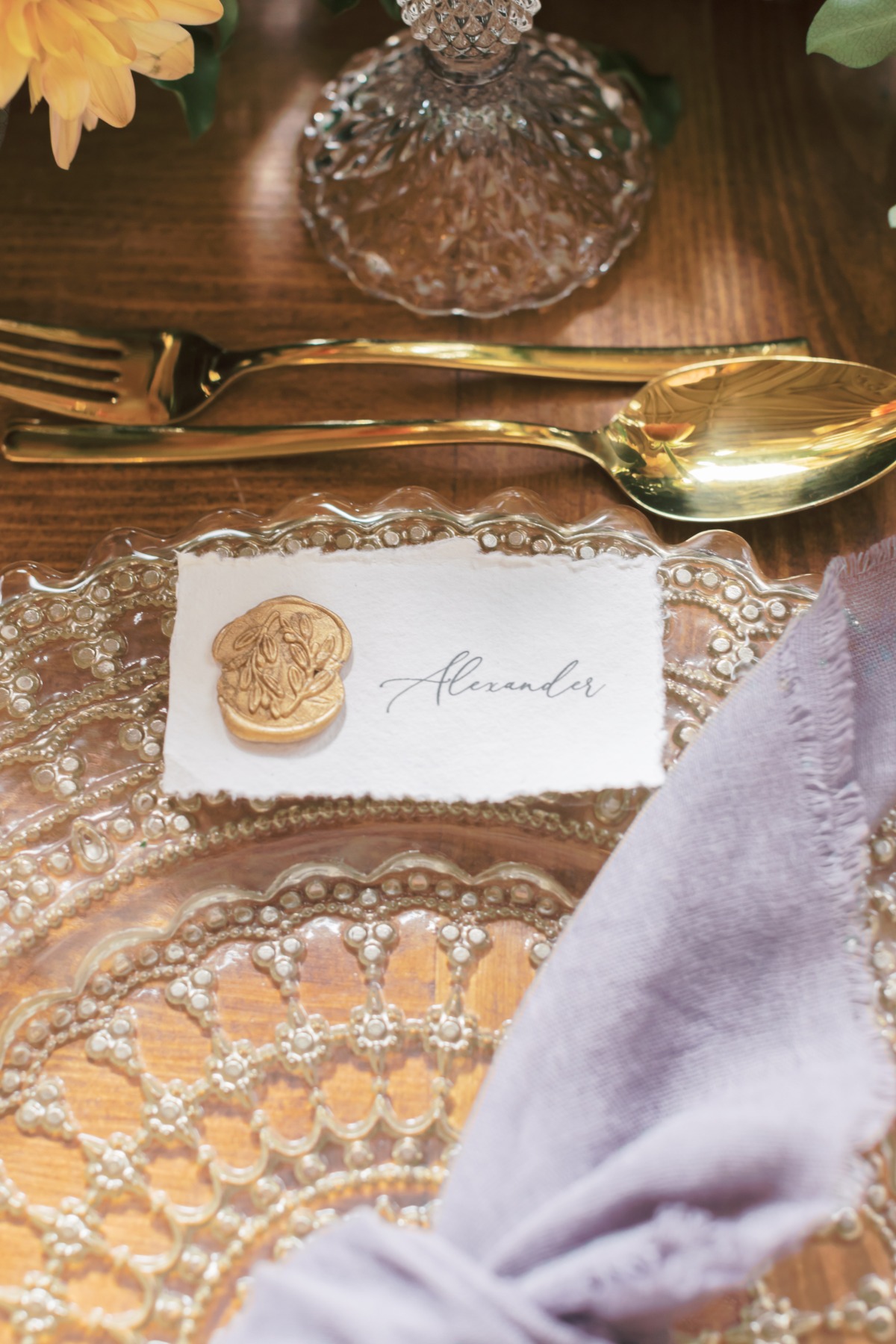 Elegant table setting with personalized name card and gold cutlery