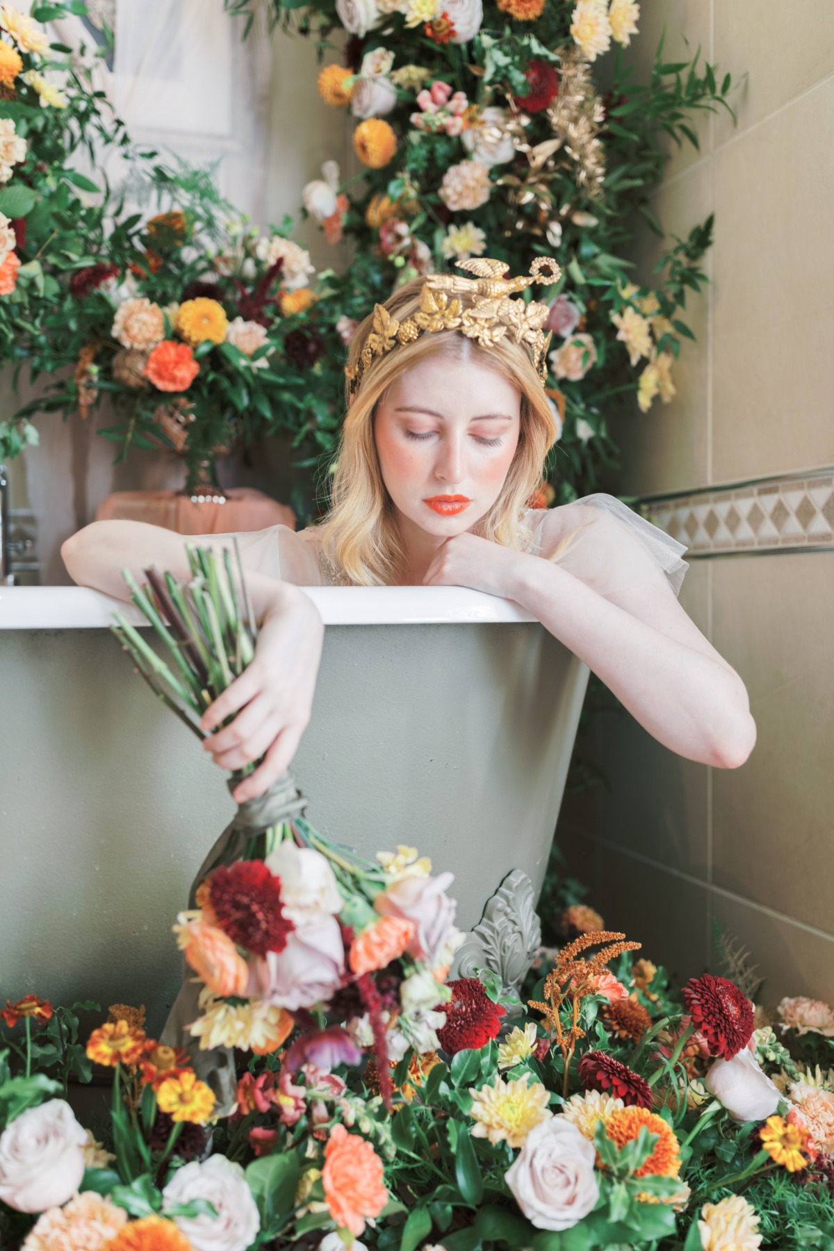 Woman in floral bath with golden crown and bouquet