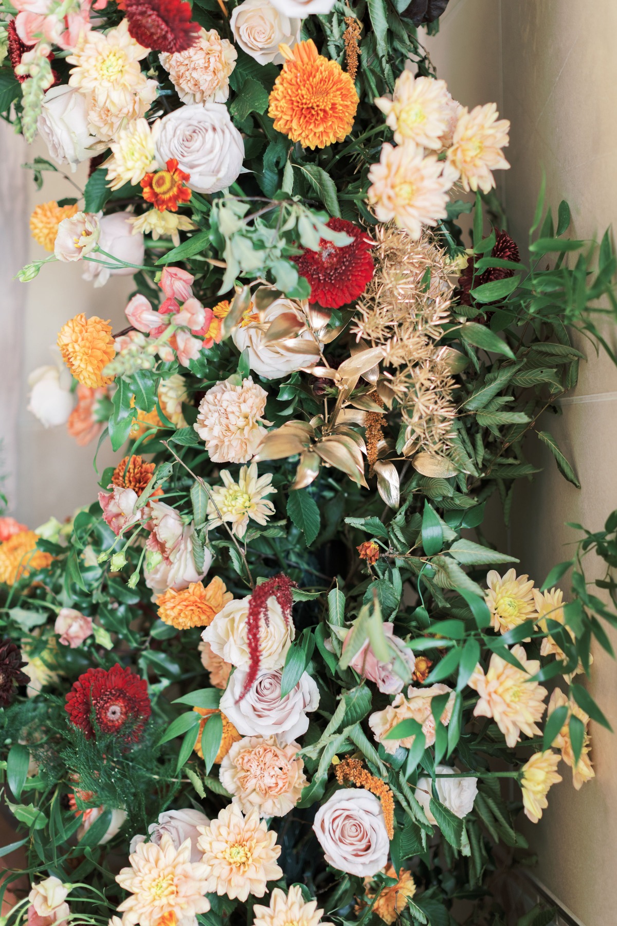 Floral arrangement with roses and mums in autumn colors