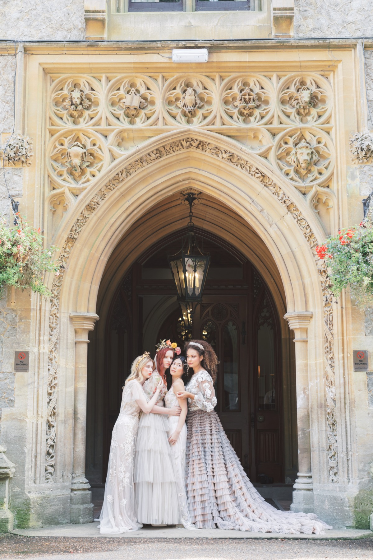 Bridesmaids pose in dresses at castle wedding venue