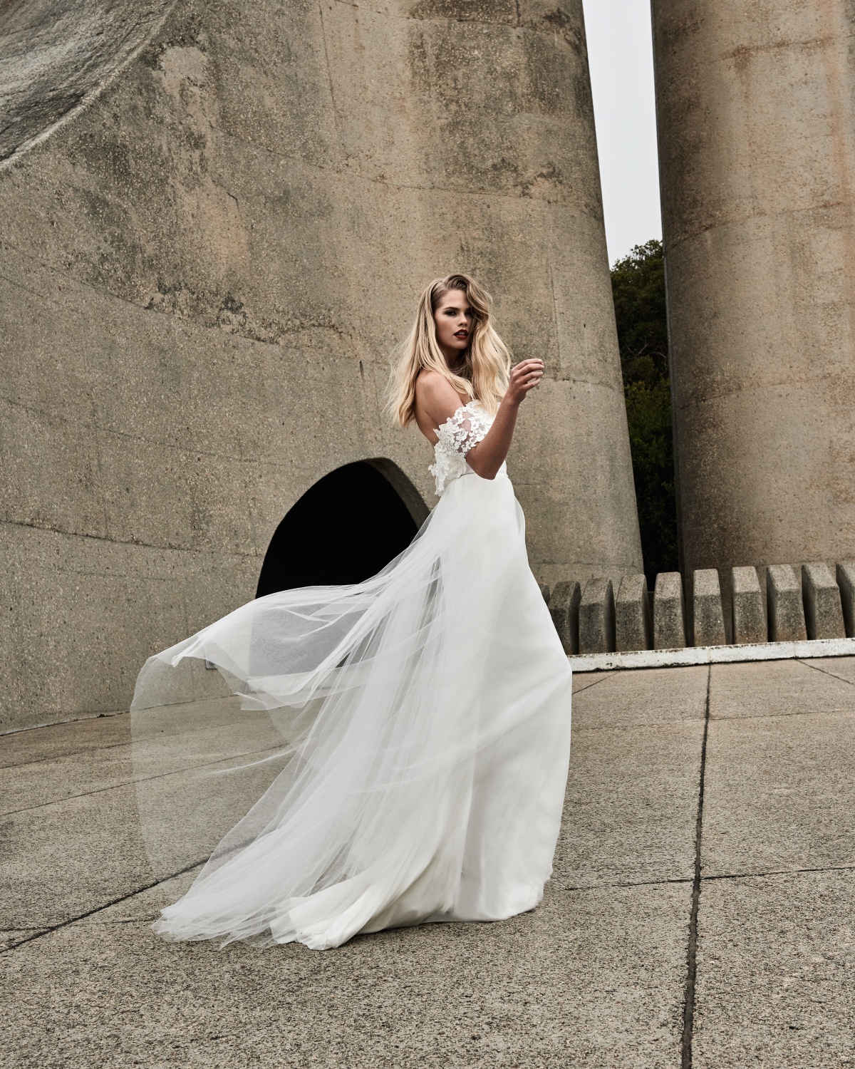 Woman in flowing off the shoulder wedding gown