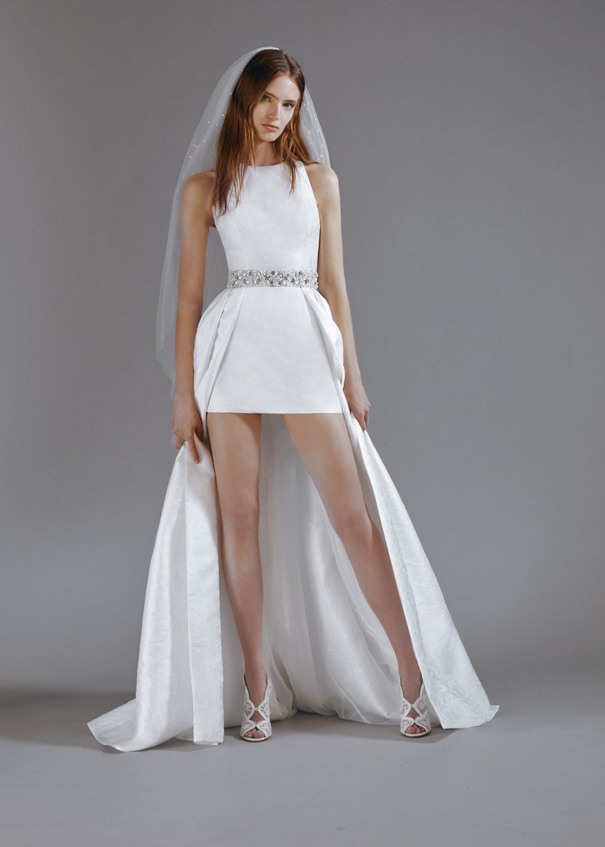 Modern bride in chic mini wedding dress with long train