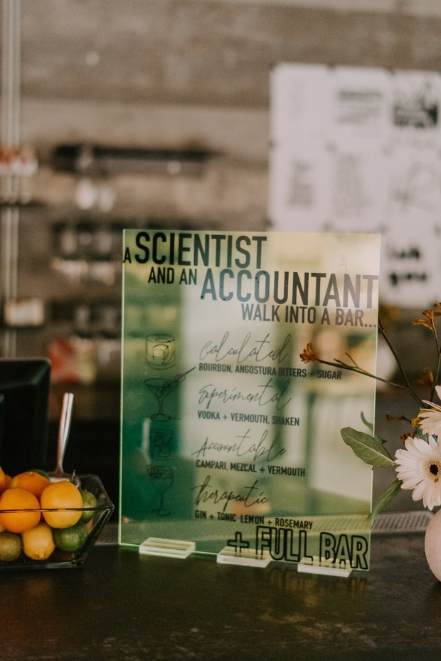 Acrylic bar sign with cocktail names and fresh citrus fruit