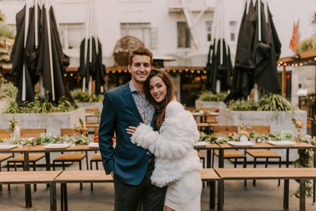 Happy couple embracing in a lovely outdoor dining scene