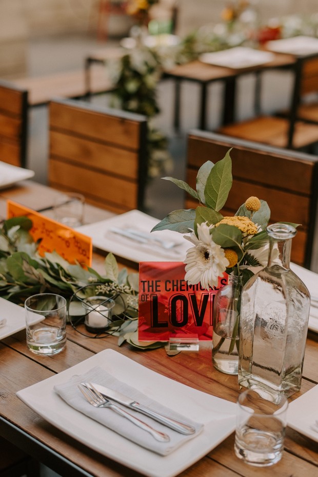 Wedding table setting with flowers and a Chemistry of Love sign