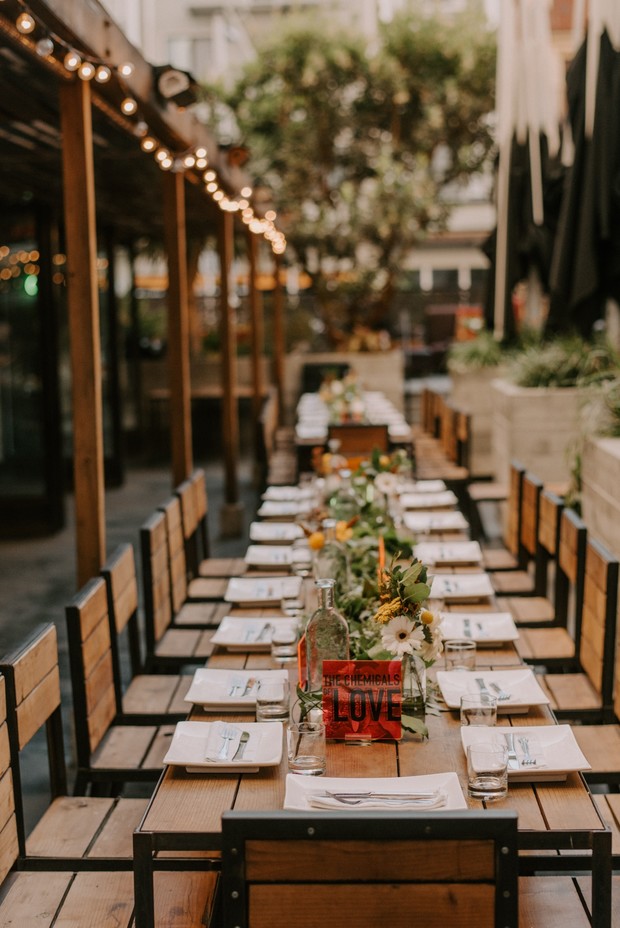 Long wedding reception table with LOVE sign and floral arrangement