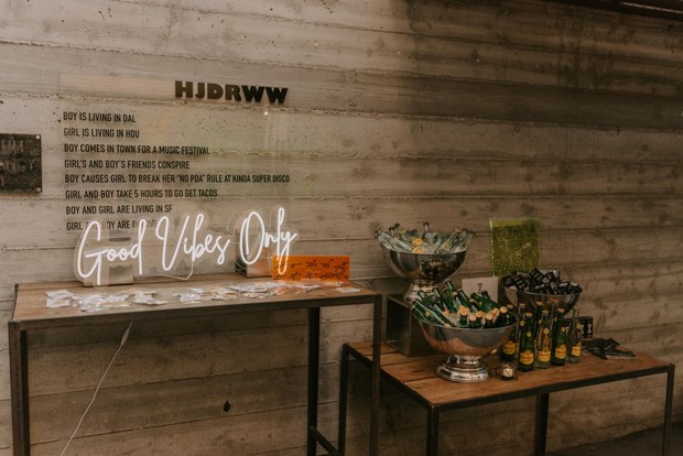 A stylish party with a Good Vibes Only neon sign and drinks