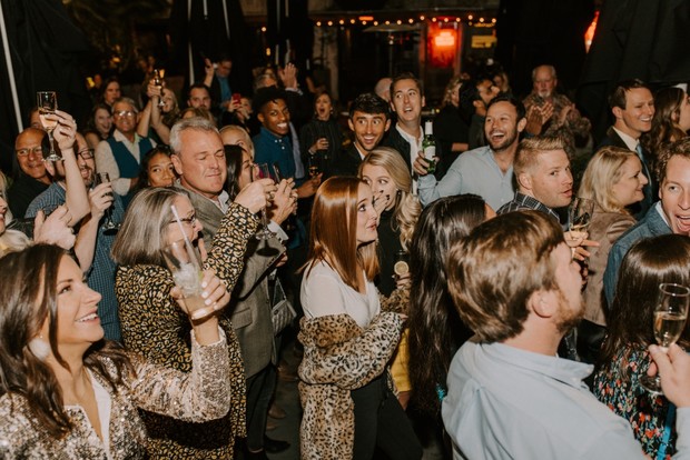 A group of joyful people celebrating and toasting together at a party