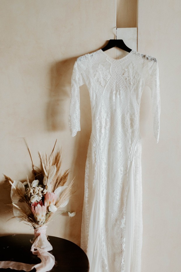 Elegant lace wedding dress with floral bouquet detail