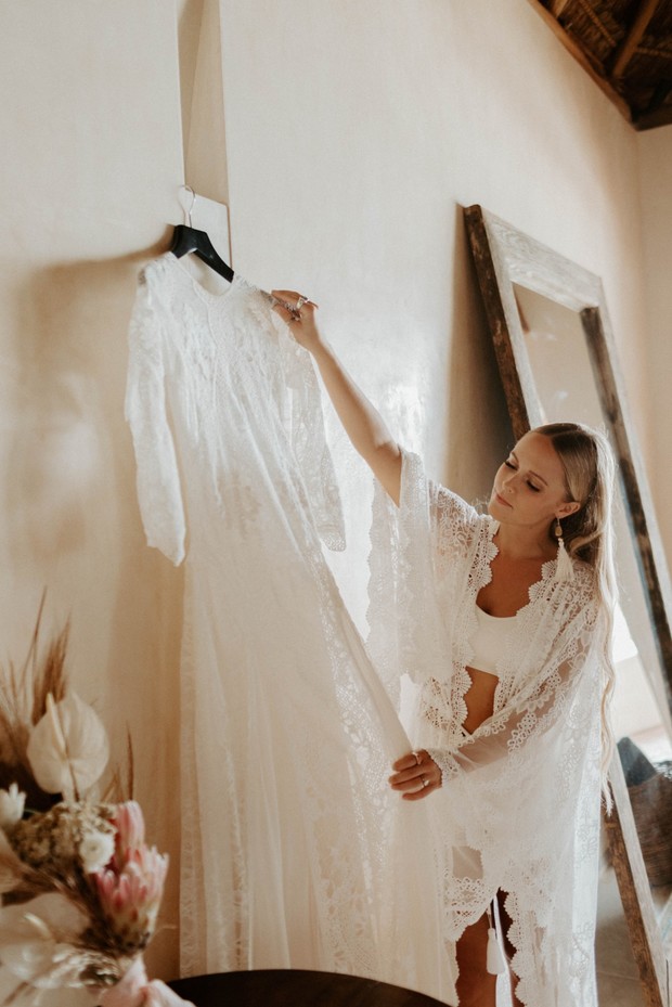 bride getting ready in lace robe