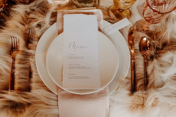 Elegant table setting with menu card and golden cutlery