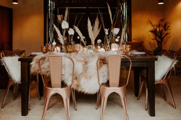 Rustic table setting with fur and rose gold chairs