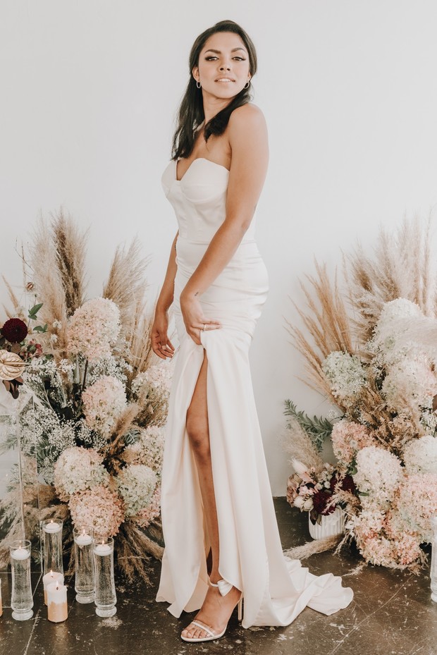 Bride in elegant ivory strapless slit wedding dress