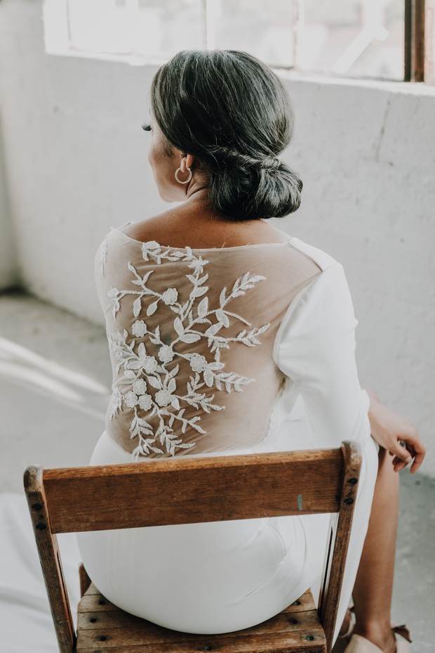 Bride in a white dress with floral lace back detail
