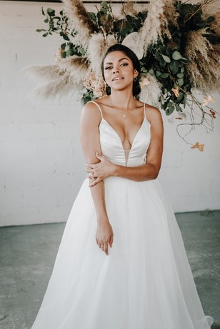 Elegant bride in white wedding dress smiling for the camera