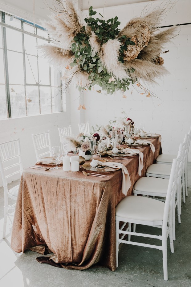 Elegant wedding table setting with floral chandelier decor