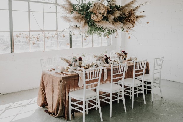 Elegant event table setting with floral and hanging decor