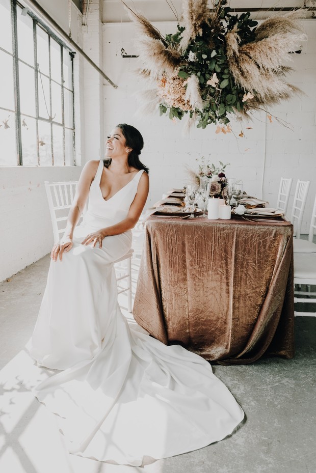 Smiling bride in a white dress at a beautiful wedding reception