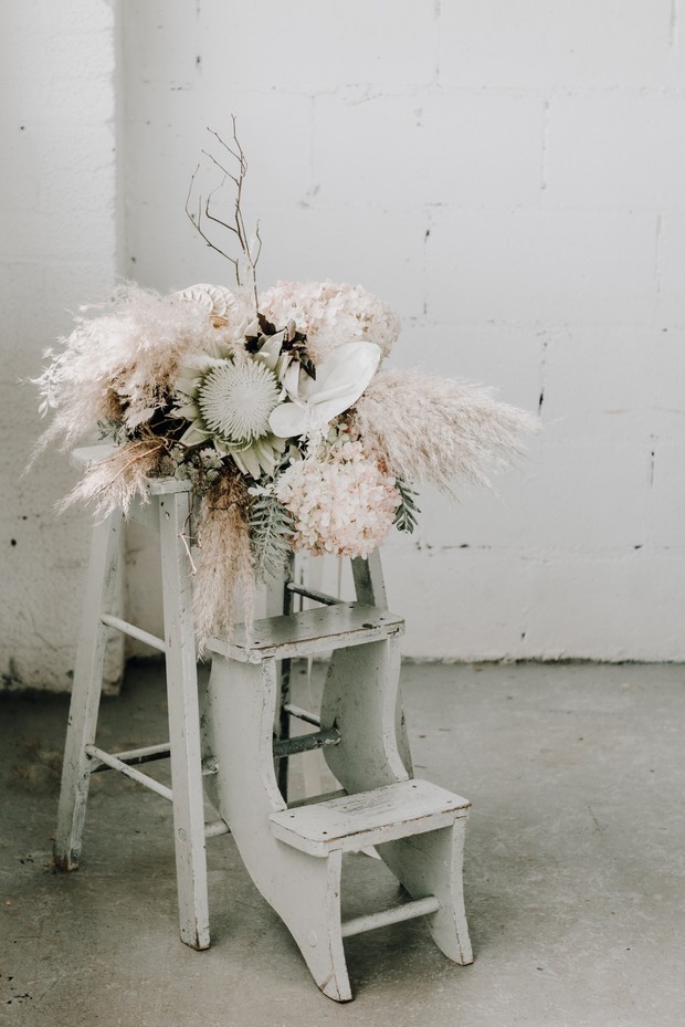Neutral dried flower arrangement on vintage white step stool