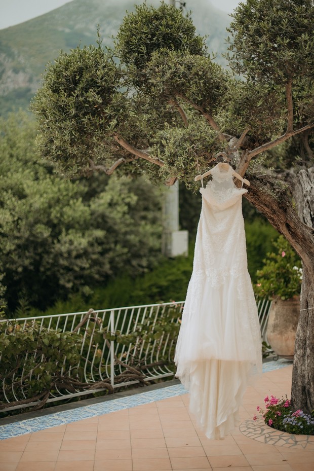 Elegant wedding dress hanging on a tree branch outdoor