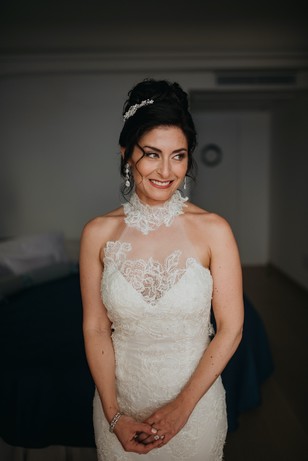 Bride smiles in a lace wedding dress on her wedding day