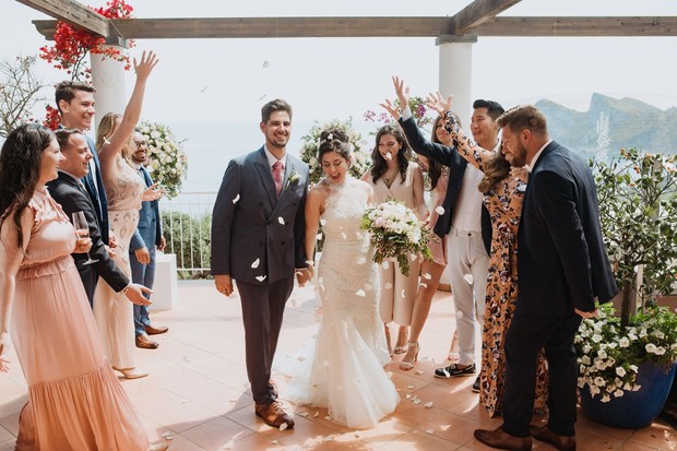 Newlyweds showered with petals at their scenic wedding
