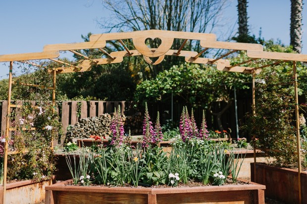 Wooden archway with heart over a beautiful flower garden