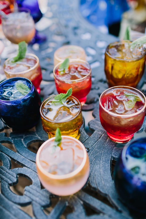Colorful cocktails with ice and mint on an ornate table