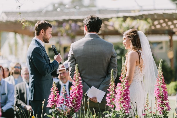Bride and groom at outdoor wedding ceremony with officiant