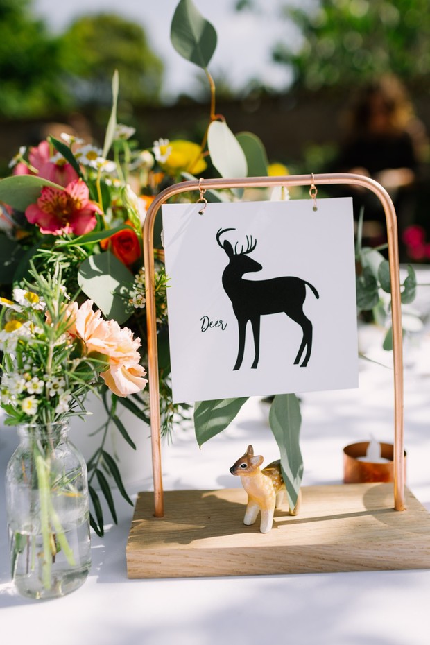 Deer themed table decoration with flowers greenery