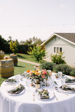 Elegant outdoor wedding table setting with floral centerpiece