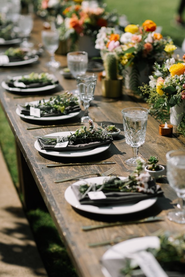 Rustic wooden table setting for outdoor wedding reception