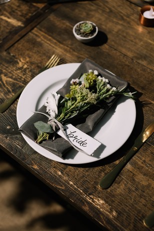 Bride place setting with flowers on rustic wooden table