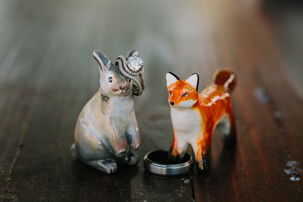 Wedding rings displayed on fox and bunny figurines