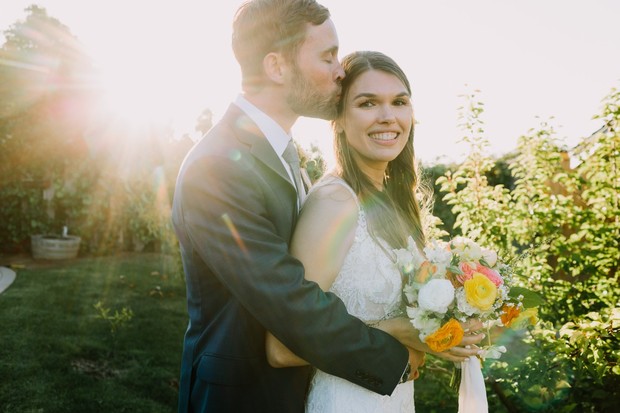 Bride and groom embracing on their sunny wedding day