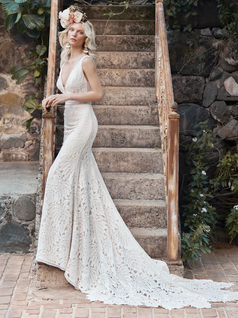 Woman in elegant lace wedding gown with long train