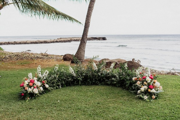 Beach wedding floral arrangement ceremony backdrop