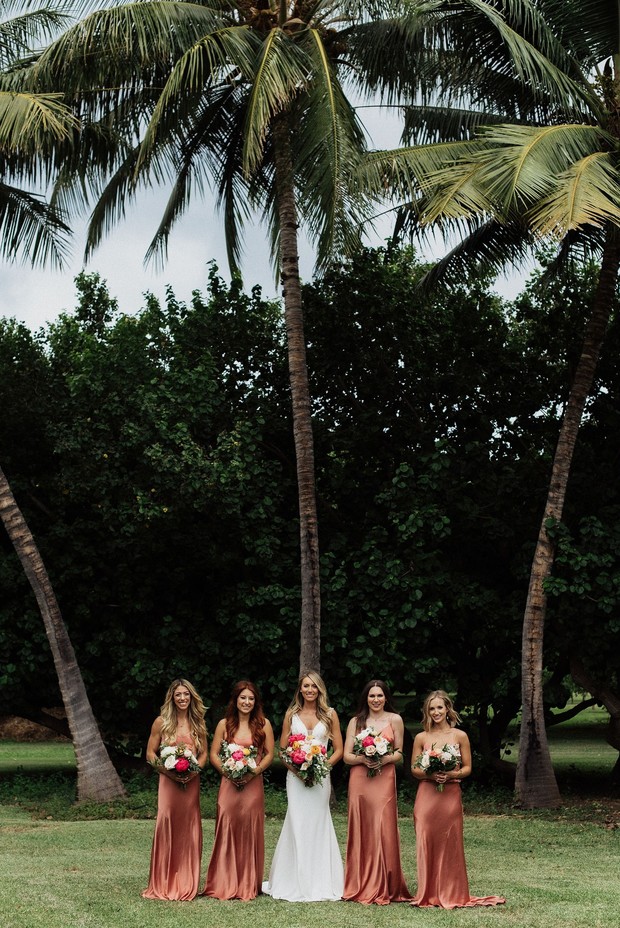 Bride and bridesmaids under palm trees outdoor wedding