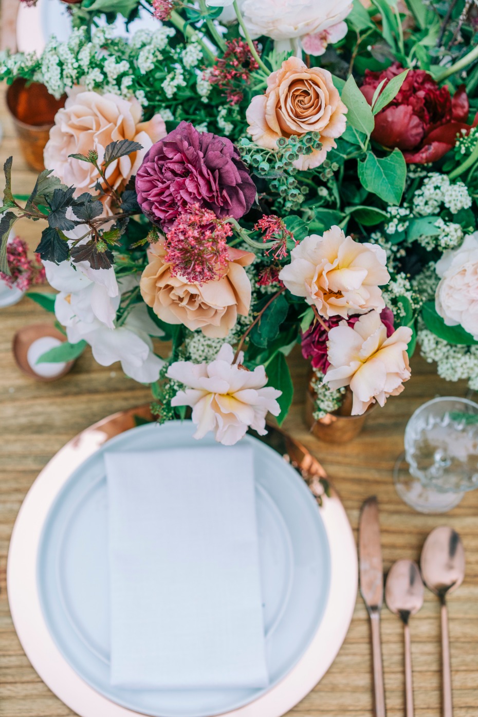 Elegant floral arrangement on a beautifully set wedding table