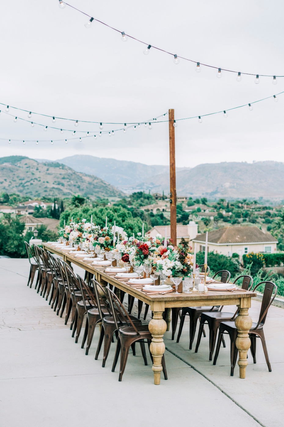Outdoor wedding reception table with floral centerpieces