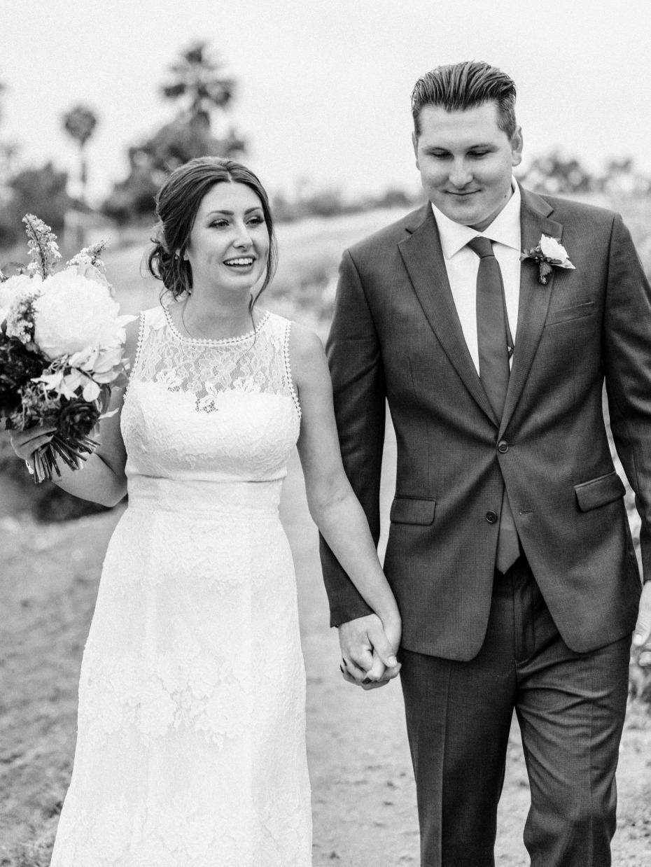 Happy bride and groom holding hands on their wedding day