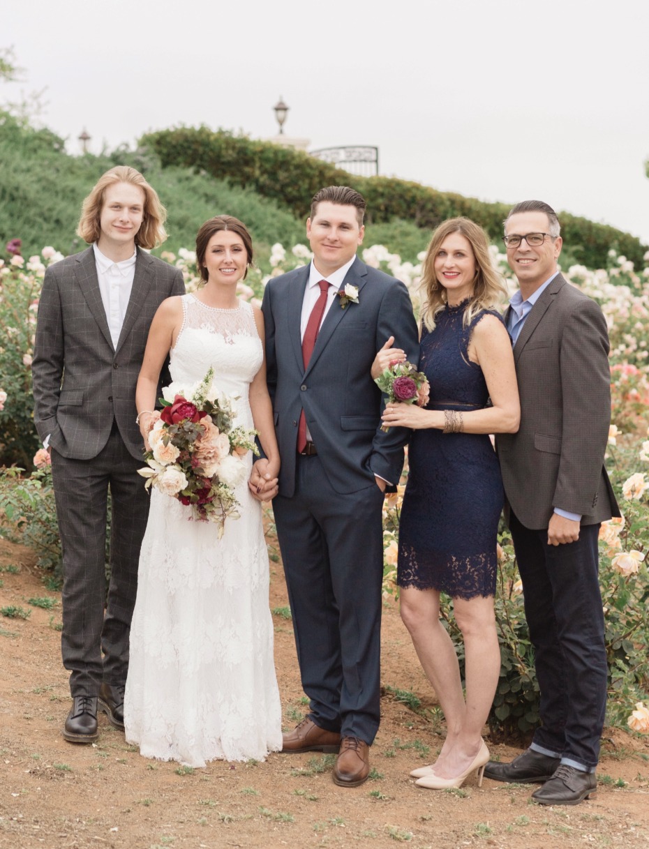 Bride and groom with family at outdoor wedding ceremony