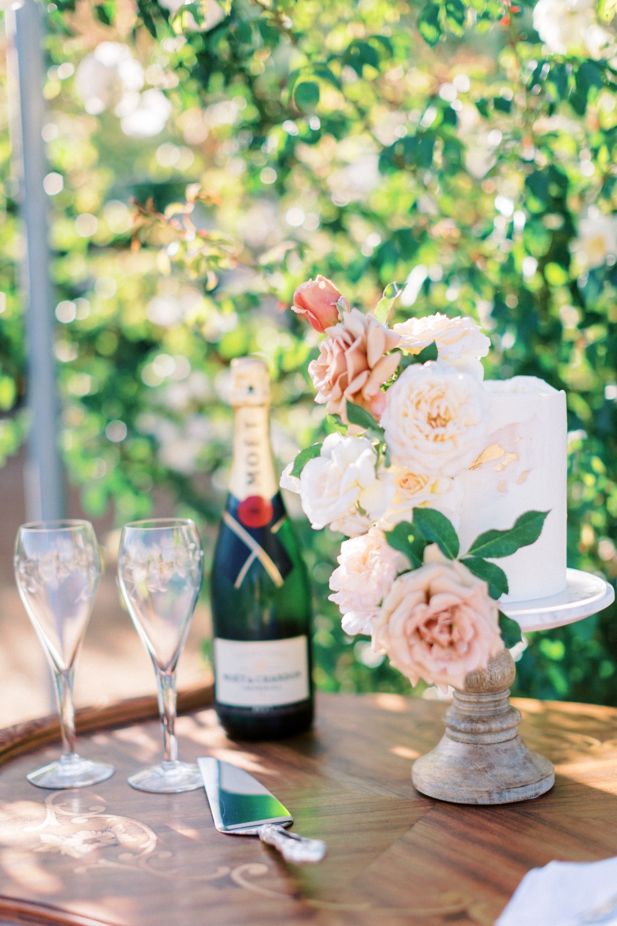 Wedding cake with flowers champagne glasses and a bottle