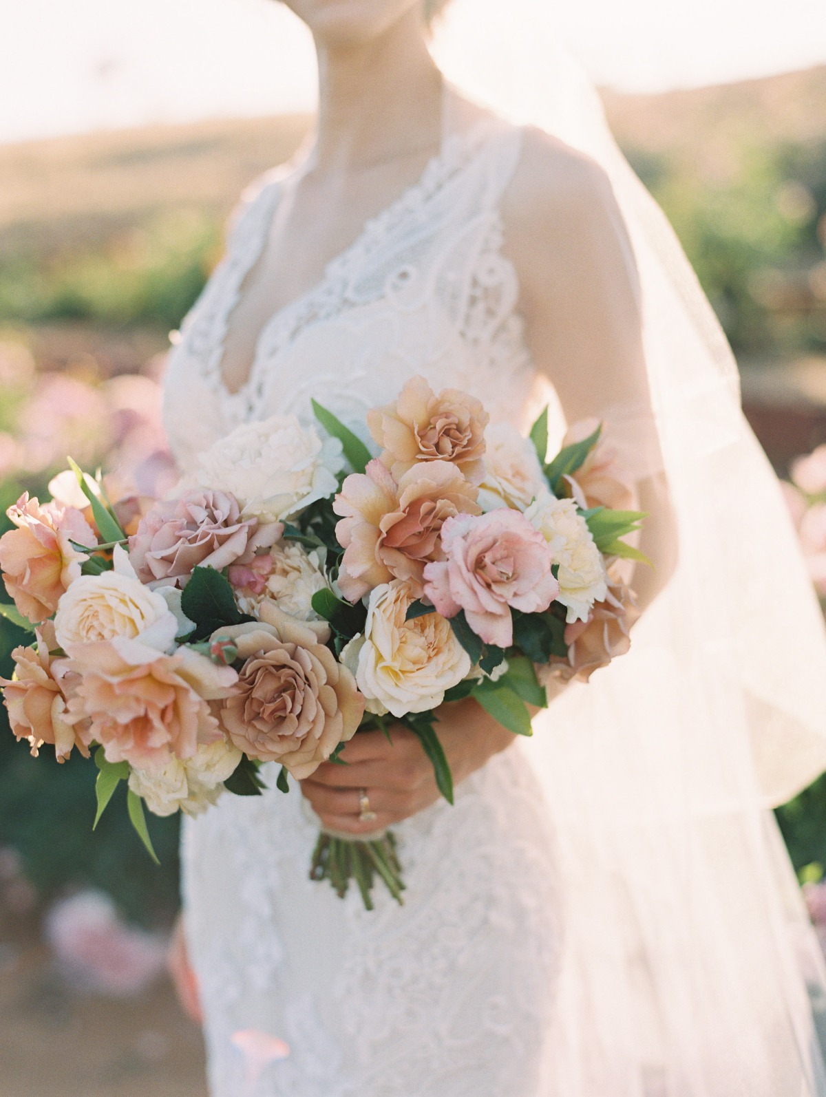 Bride holding a beautiful bouquet of roses on her wedding day