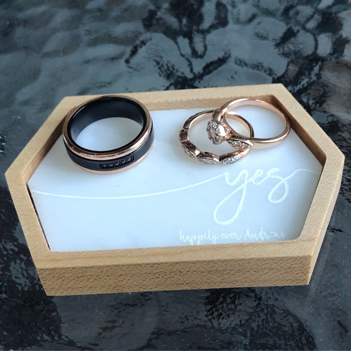 Wedding rings on a tray with yes written, ready for the ceremony