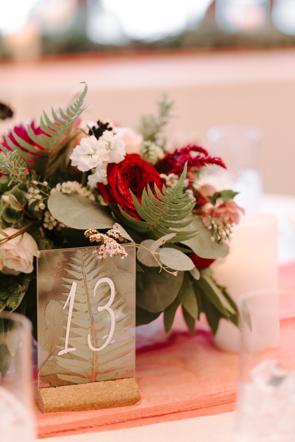table numbers with plants with greenery in them