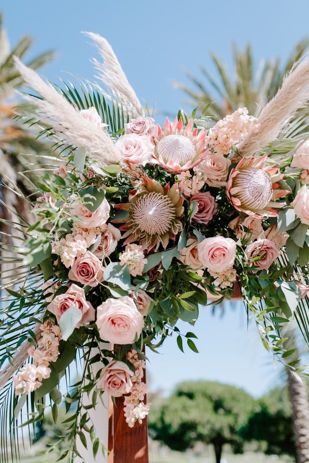 protea, roses and eucalyptus wedding arrangement