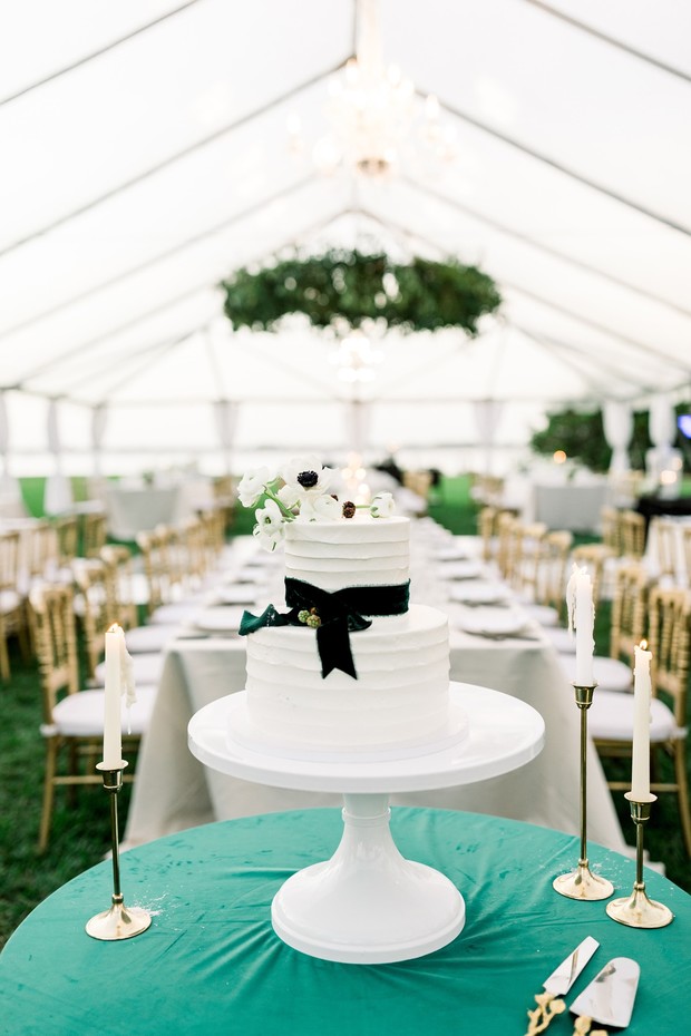 white wedding cake with green velvet bow