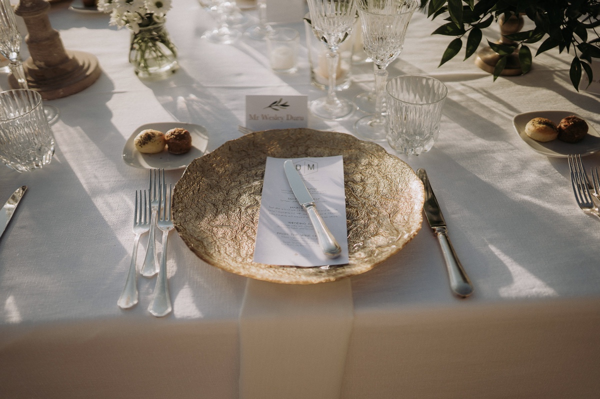 gold wedding plate paired with silver cutlery