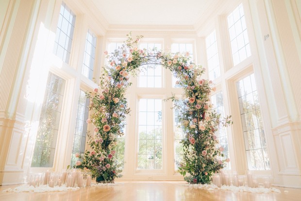 floral wedding arch decorated with candles